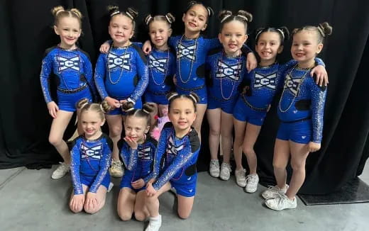 a group of girls in blue uniforms