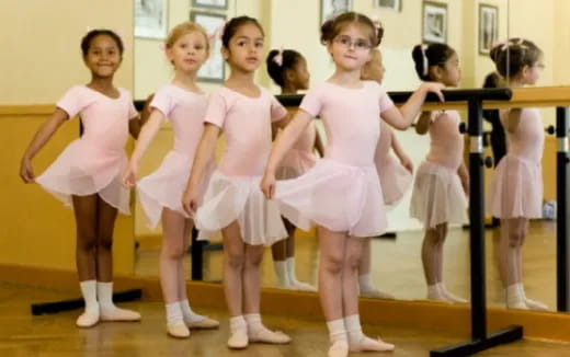 a group of girls in dresses dancing