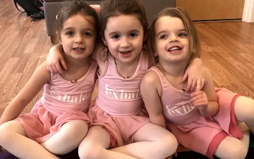 a group of girls sitting on the floor