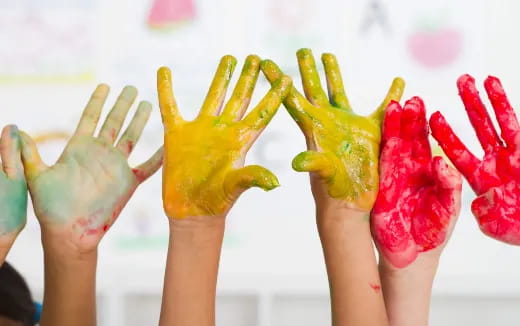 a group of hands holding fruit