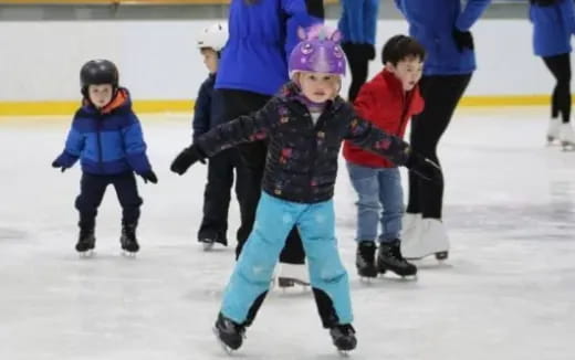 a group of kids ice skating