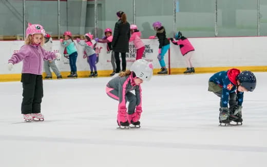 a group of kids on ice skates