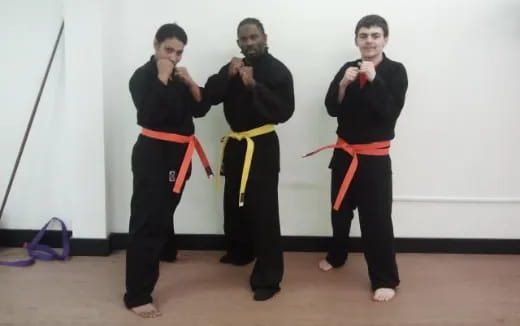 a group of men in black martial arts uniforms