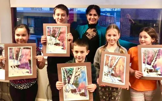 a group of people holding framed pictures
