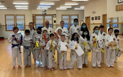 a group of people in karate uniforms