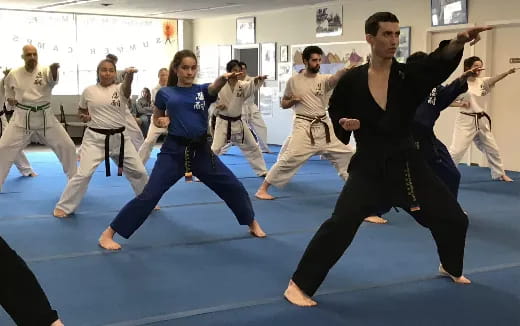 a group of people in karate uniforms