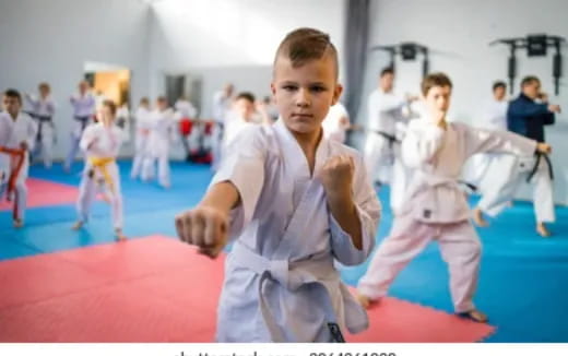 a group of people in karate uniforms