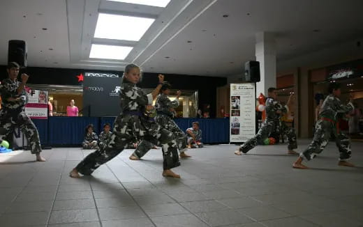 a group of people in military uniforms dancing in a room