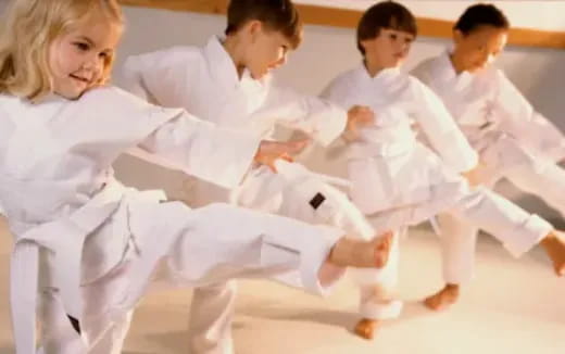 a group of people in white karate uniforms