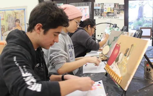 a group of people looking at a book