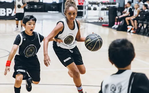 a group of people playing basketball