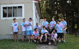 a group of people posing for a photo in front of a house