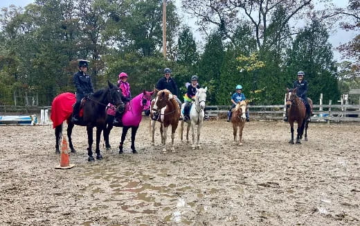 a group of people riding horses