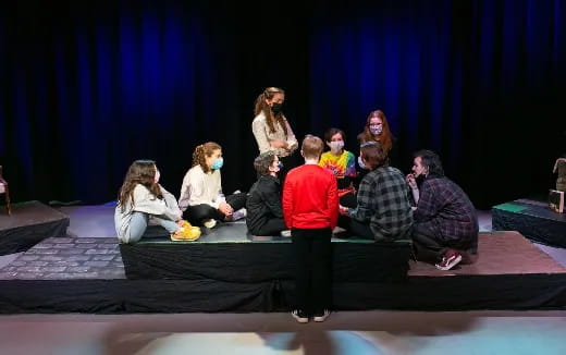 a group of people sitting on a stage