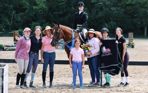 a group of people standing around a horse