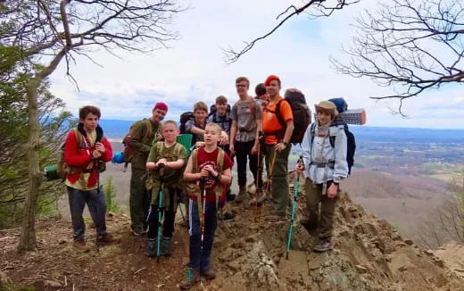 a group of people standing on a hill