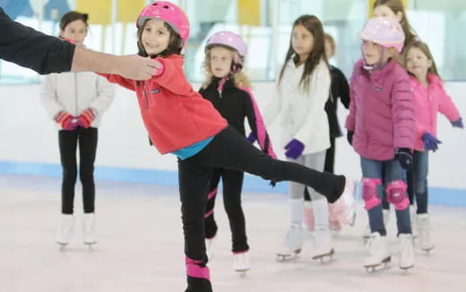 a group of people wearing ice skates and helmets