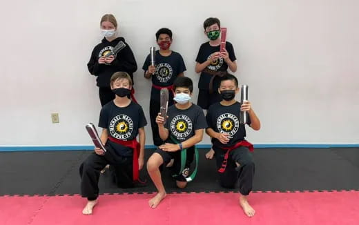 a group of people wearing masks posing for the camera