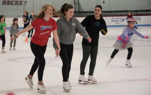 a group of women ice skating