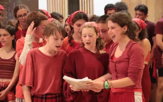 a group of women in red shirts