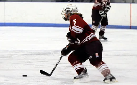 a hockey player in red and white uniform on ice