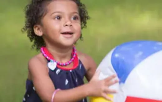 a little girl holding a frisbee