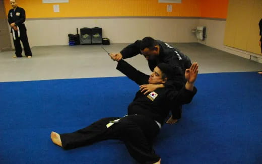 a man and a woman in a karate uniform