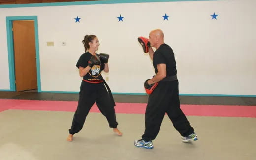 a man and a woman in a martial arts class
