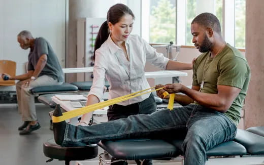 a man and a woman in a room with a man sitting on a chair