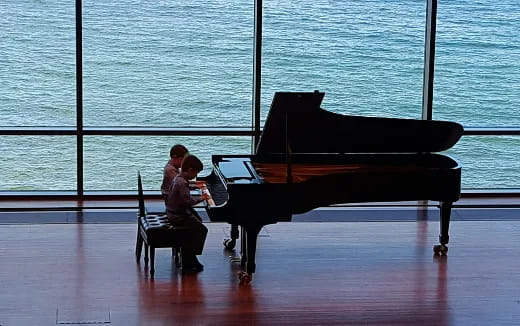a man and a woman playing piano