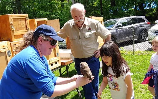 a man and woman holding a bird