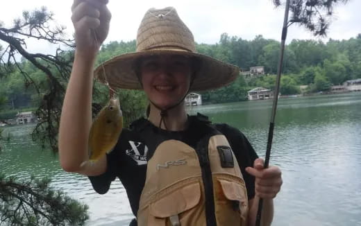 a man holding a banana and a fishing pole