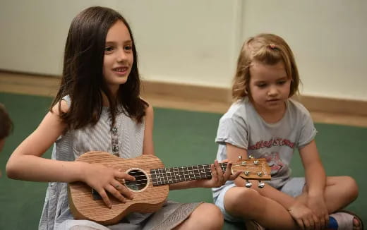 a person and a child playing guitar