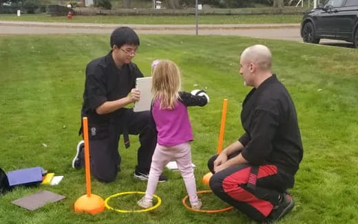 a person and a little girl playing with a toy