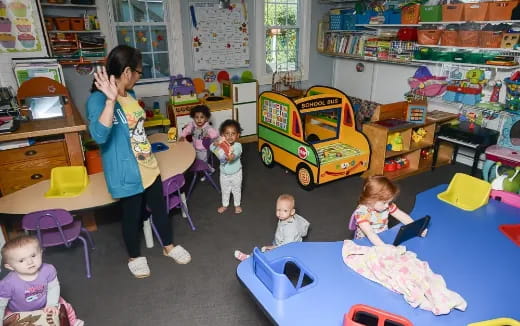 a person and children in a classroom