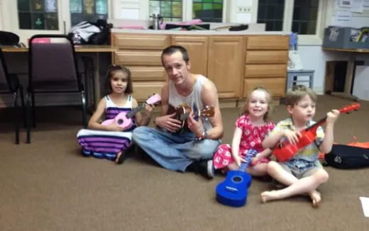 a person and two children sitting on the floor