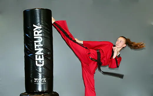 a person posing next to a tire