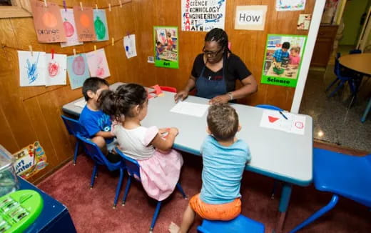 a person teaching children in a classroom