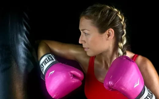 a woman wearing boxing gloves