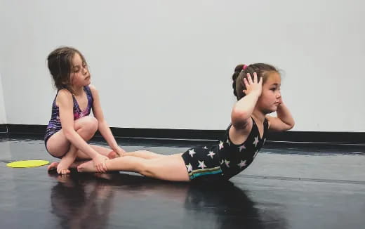 two girls sitting on the floor