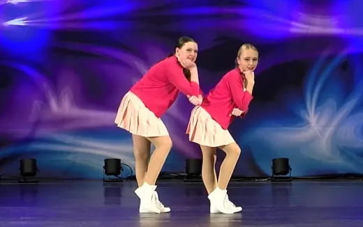 two women dancing on a stage