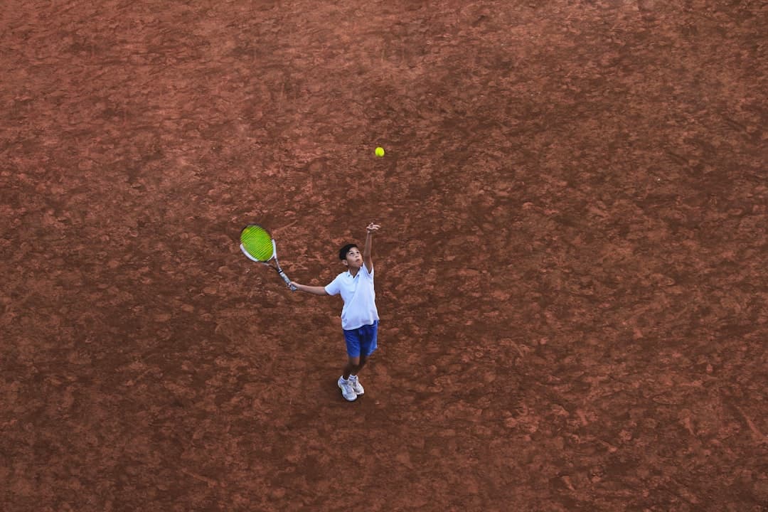 child holding racket