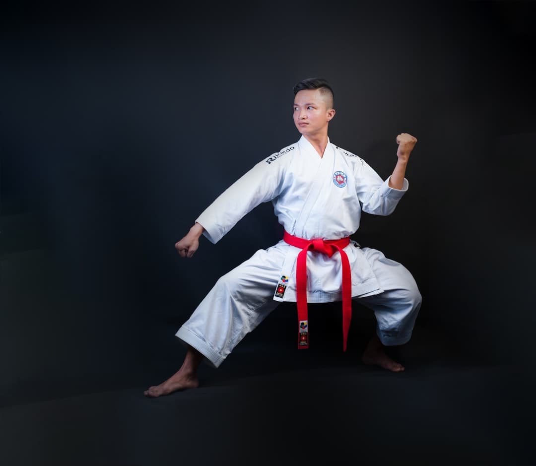 man standing wearing white karate gi