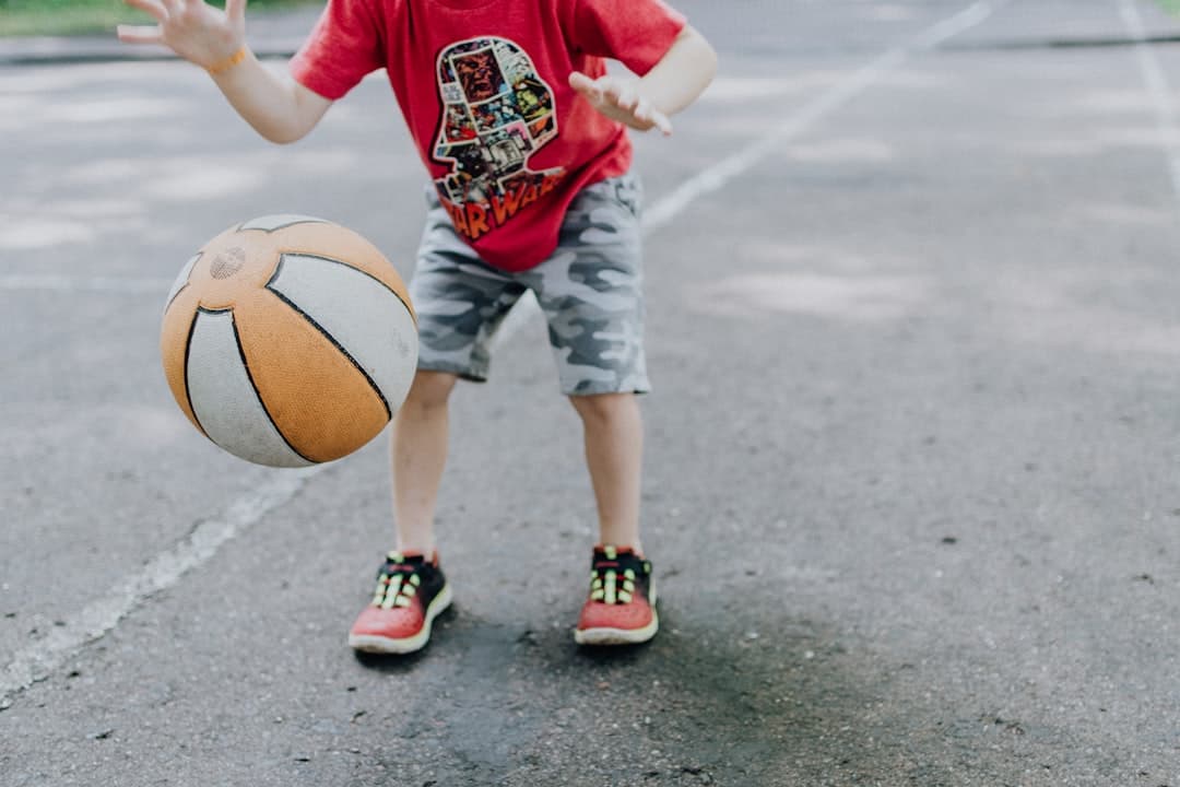 boy playing ball at daytime