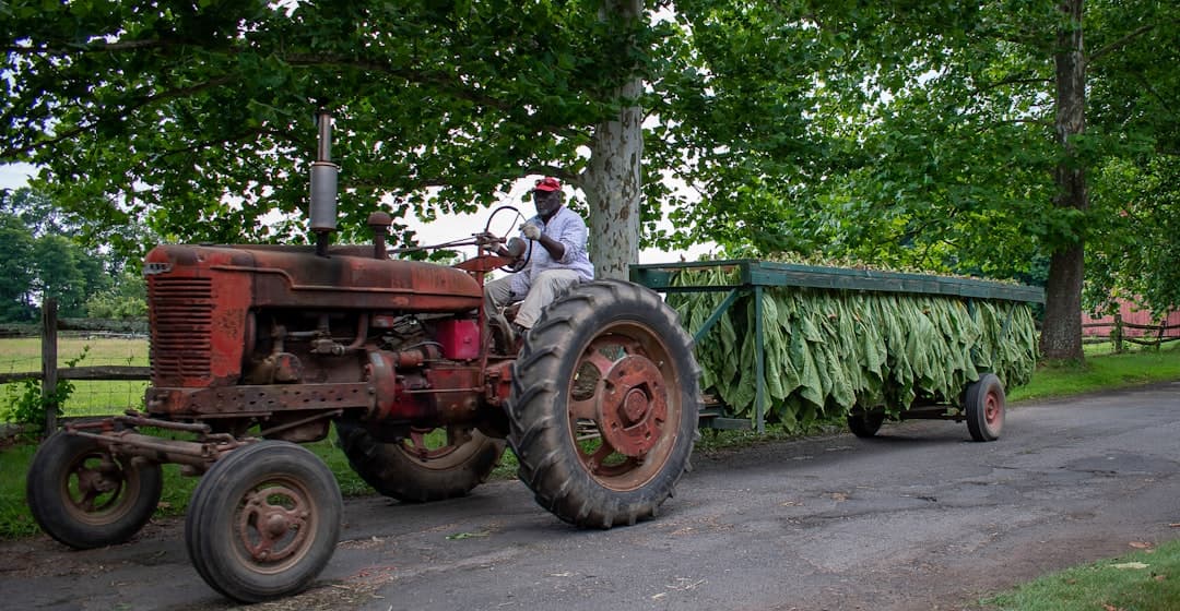 a man riding on the back of a tractor