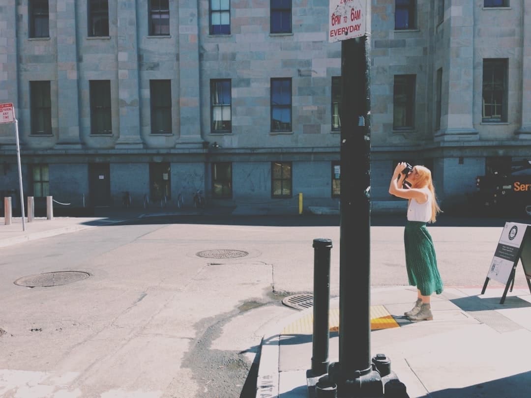 woman in green dress sitting on white bench during daytime