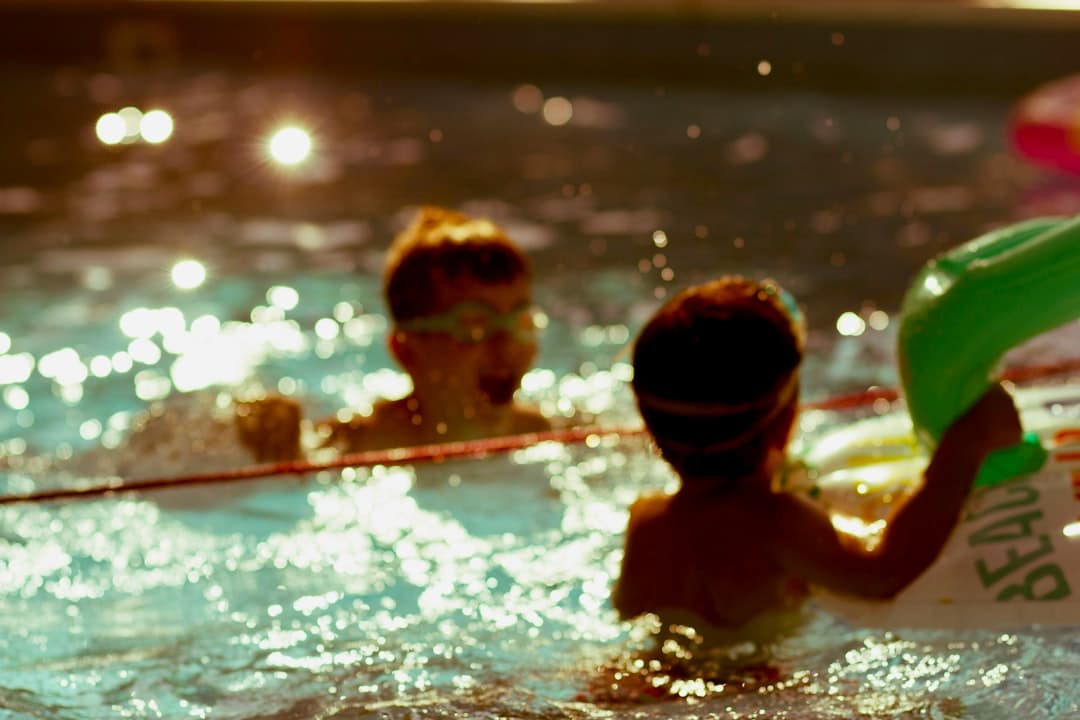 2 boys in swimming pool during daytime