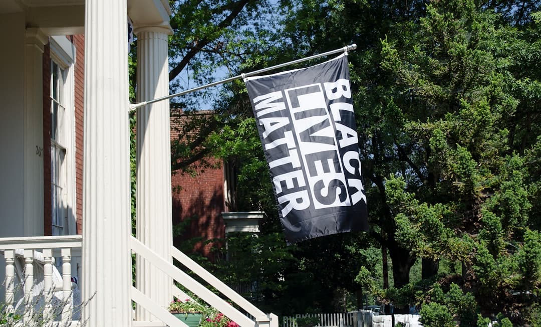 a black and white banner hanging from the side of a house