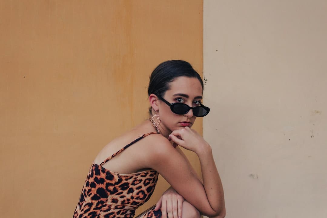 woman in leopard print brassiere and black sunglasses
