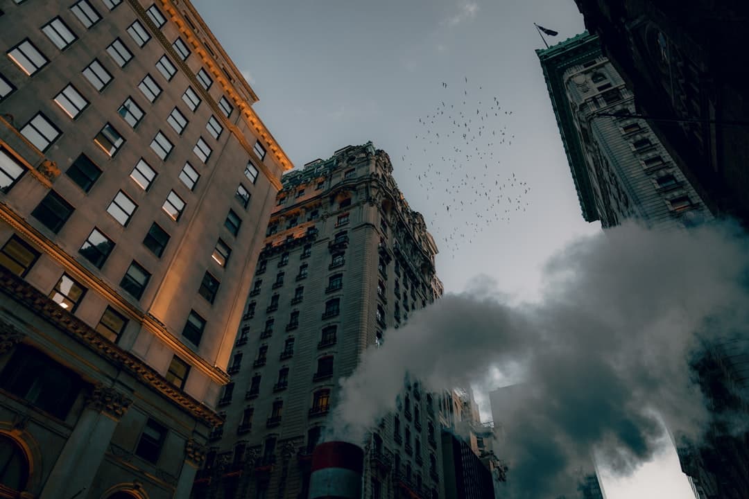 low angle photography of high rise buildings under cloudy sky